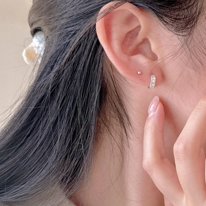 Minimalist 925 sterling silver hoop earrings with sparkling cubic zirconia on model