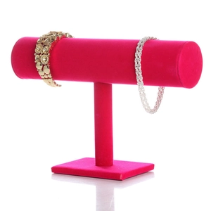 Rose red velvet T-bar jewelry display stand showing gold bracelets on white background