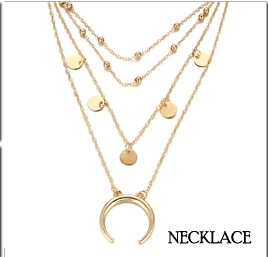 Detail view of gold-plated layered necklace featuring moon and bead pendants in boho style