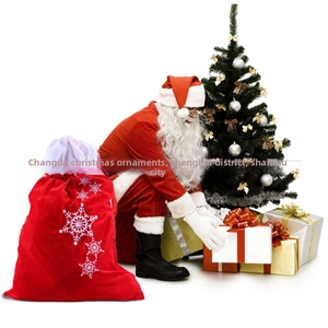 Detail of red velvet Christmas gift sack with embroidered snowflakes and white drawstring