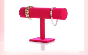 Detail of hot pink velvet T-bar jewelry display stand with a thick base for bracelets