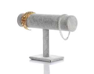 Macro shot of grey velvet T-bar display stand showing texture and stability for jewelry