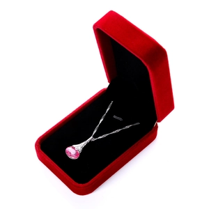 Close-up of pink teardrop gemstone necklace inside a premium red velvet jewelry box
