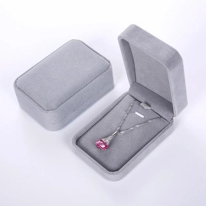 Gray velvet jewelry box for necklaces in both open and closed positions on white background