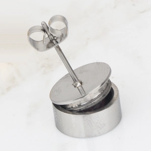 Detail view of 11mm cylindrical stainless steel stud earrings with butterfly backings