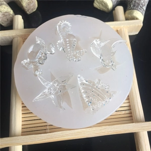 Detailed macro view of a round silicone mold featuring seahorse, starfish, and crab shapes