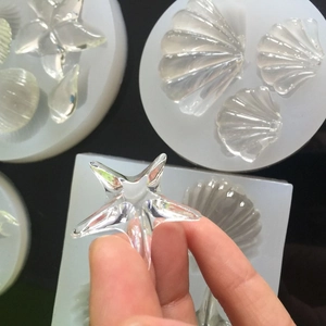 White silicone resin molds and finished ocean shell starfish ornaments for DIY crafts