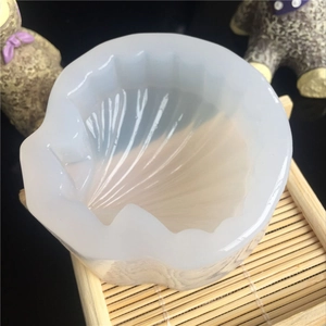 Macro shot of seashell-shaped silicone mold on bamboo tray for DIY resin craft decoration