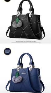 Detail of lychee pattern faux leather bag showing logo plaque and decorative fuzzy ball charm