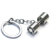 Macro shot of silver kettlebell keychain with FIT engraving on polished metal surface