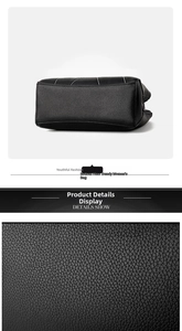 Close-up of black lychee grain leather texture and durable bottom stitching on shoulder bag