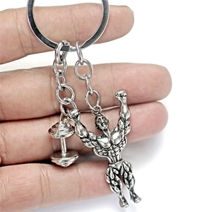 Silver metal bodybuilding keychain featuring a muscular fitness figure and dumbbell pendant