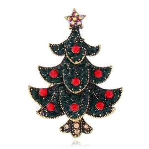 Close-up of vintage gold Christmas tree brooch with emerald and ruby rhinestones
