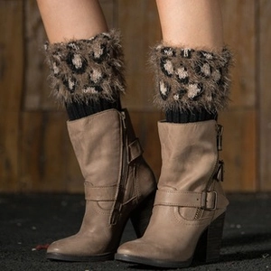 Detail view of leopard print faux fur leg warmers with black knitted ribbed cuffs