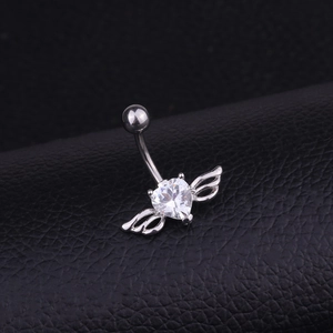 Silver heart zircon belly button ring with wings on a black leather surface