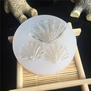 Detail of seashell shaped silicone molds for resin casting on a mini bamboo mat