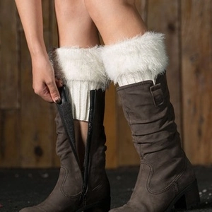 Close-up of white faux fur boot covers with knitted lining on brown leather boots