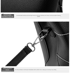 Detail of black litchi grain leather bag showing polished silver hardware and zipper