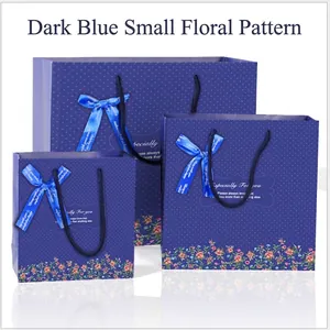 Three-piece dark blue floral gift bag set with white polka dots and ribbon bows