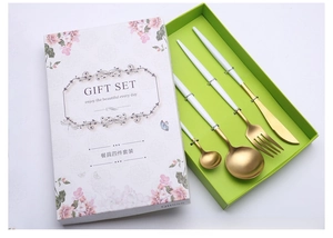 Modern gold and white stainless steel cutlery gift set in floral packaging