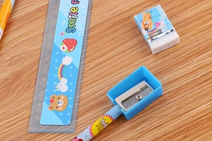 Detailed set of blue cartoon stationery including a 15cm ruler, eraser, and pencil on wood