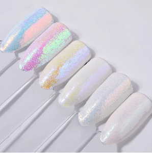 Macro detail of six white aurora nail powder swatches with iridescent glitter effect