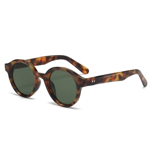 Retro oval tortoise shell sunglasses with dark green lenses and silver rivet details