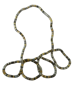 Macro detail of flexible snake bone chain in silver and gold metallic finish