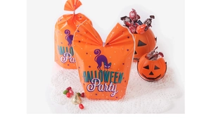 Detail of orange Halloween cookie bags with long rabbit ear ties and black cat print