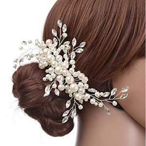Detailed view of handmade bridal hair comb with pearls and leaf crystals for wedding styles