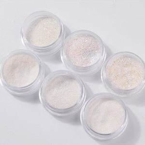 Set of six white shimmering nail glitters with iridescent finish in transparent jars