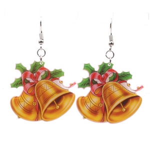 Detailed view of Christmas bell earrings with red bow and green holly festive charms