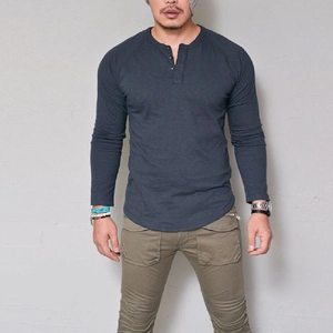 Men's slim fit navy blue long sleeve Henley shirt with three-button neckline and curved hem