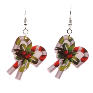 Detail of festive Christmas candy cane earrings in red and green acrylic with silver hooks