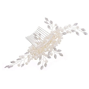 Detailed close-up of bridal hair comb with pearls and silver leaf branch accents