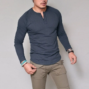 Detail of dark blue men's long sleeve Henley shirt with button neckline and knit texture