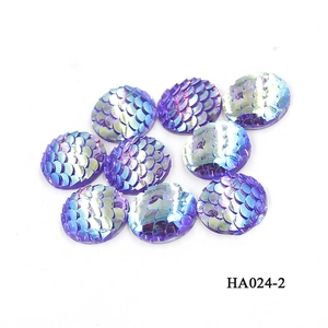 Macro shot of 16mm purple resin fish scale cabochons with iridescent mermaid shimmer