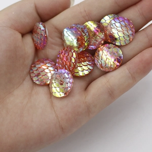 Macro shot of 16mm AB colorful resin round fish scale charms held in a hand for DIY jewelry