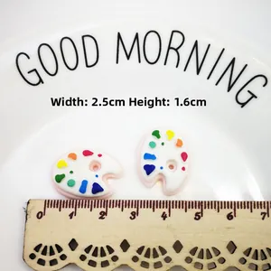 Detailed view of colorful resin palette charms for DIY crafts with size measurements