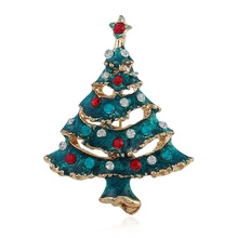 Detail of Christmas tree brooch with green enamel and multi-colored rhinestones on gold