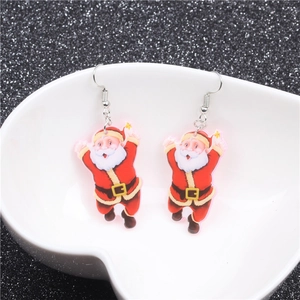 Macro view of acrylic Santa Claus earrings with silver hooks in a white heart tray