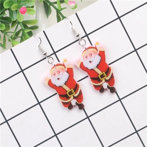 Close-up of funny Santa Claus acrylic earrings with sunglasses on a white grid background