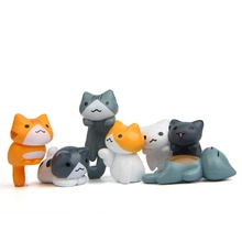 Detailed view of eight assorted miniature resin cat figurines in various cute poses