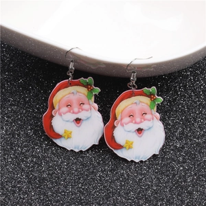Detail view of acrylic Santa Claus earrings with glitter background for Christmas vibes