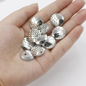 Close-up of 16mm silver resin flatback cabochons with detailed fish scale texture