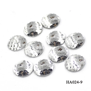Macro detail of 10 silver round fish scale resin buttons on a white background