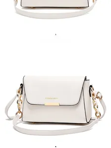 Detail of white crossbody bag with gold FASHION & BAG lettering and metallic clasp