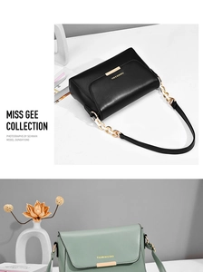 Close-up of black and green leather crossbody bags with gold metal bar details