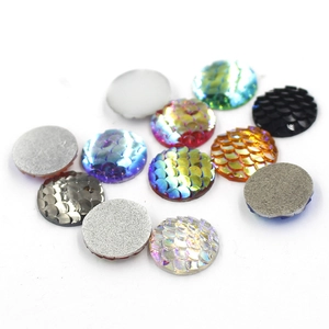 Macro detail of 16mm round resin fish scale cabochons in various iridescent colors
