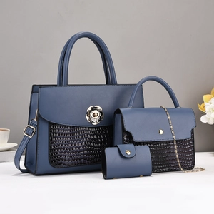 Three-piece navy blue leather tote bag set with crocodile pattern and flower buckle
